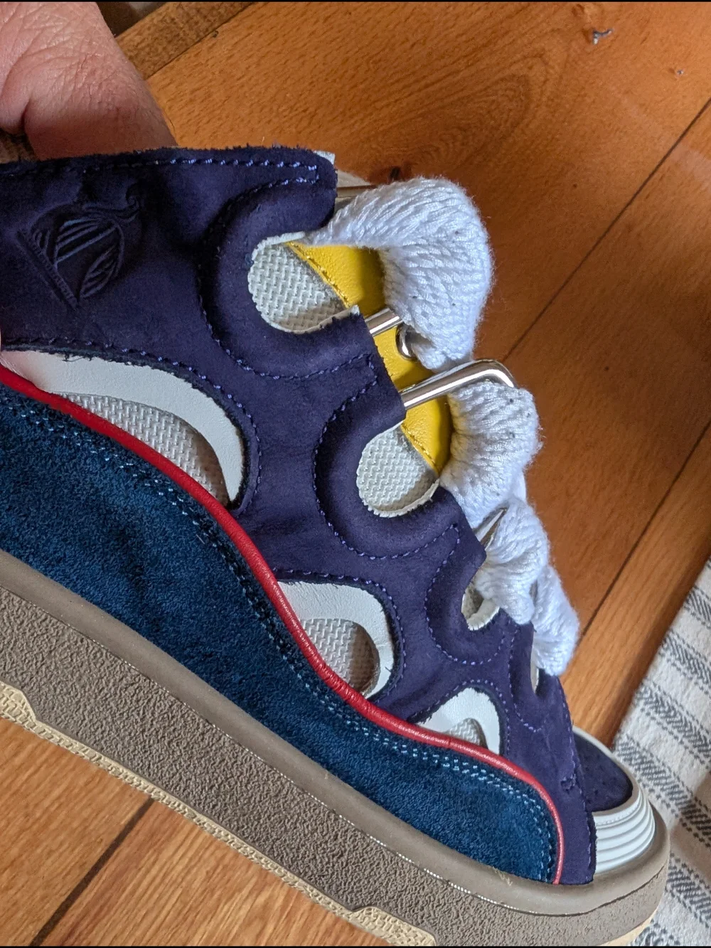 Lanvin Curb Sneakers in a distinct Navy Blue, White, Red, and Yellow colorway.